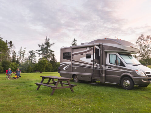 Couple relaxing near their RV