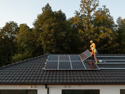 men on roof with panels